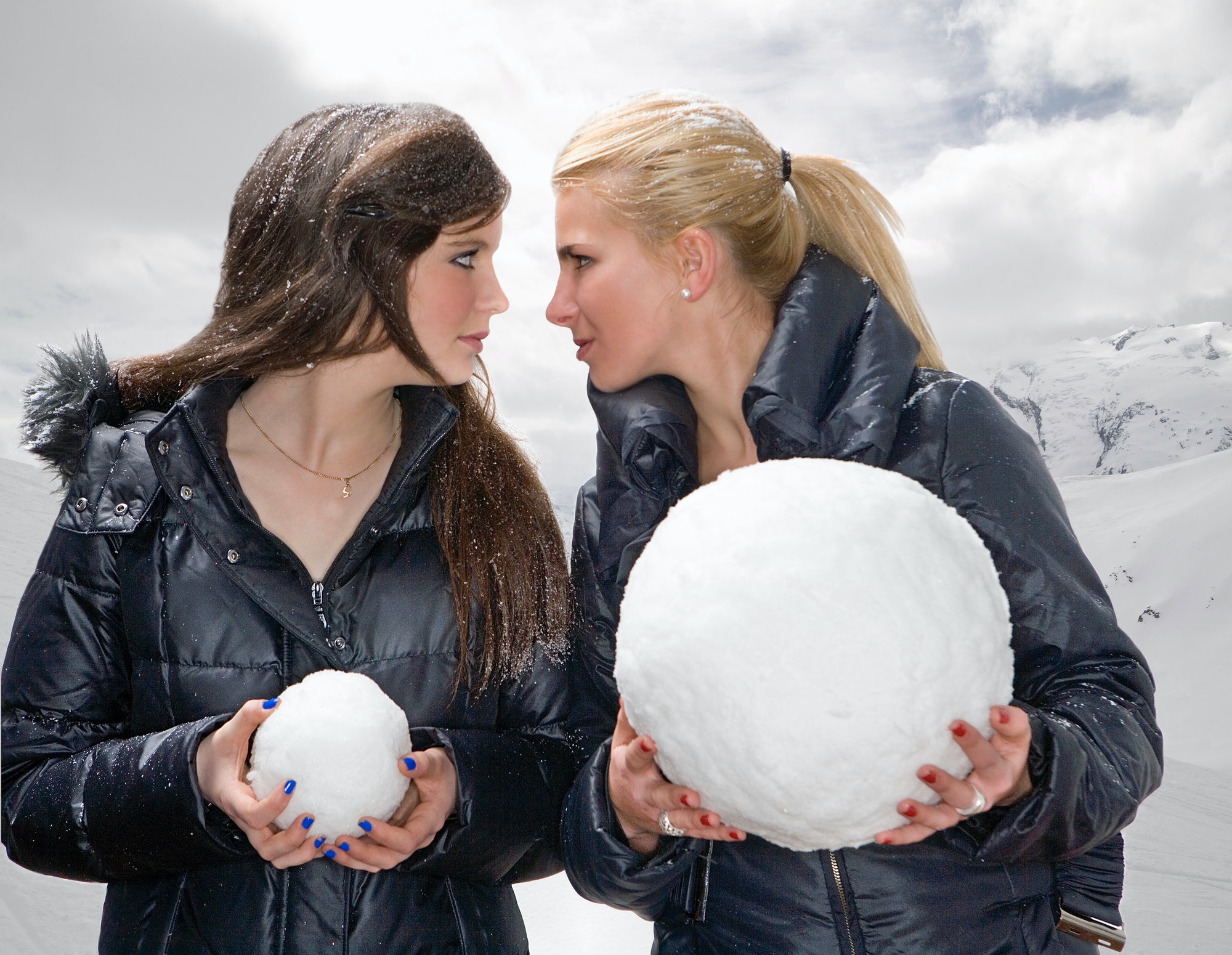 Teen girls challenge with snowballs